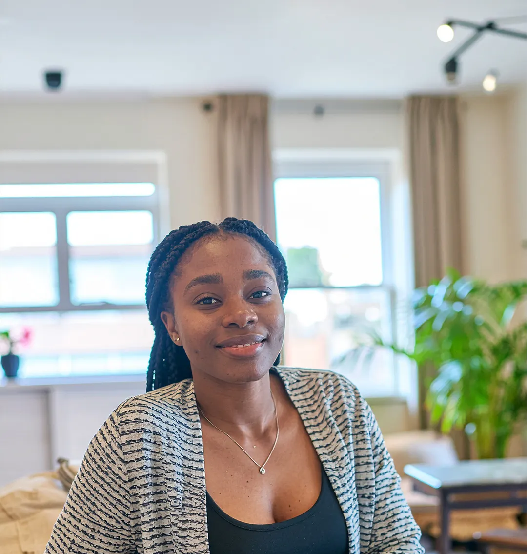 A woman sitting in a bright lounge